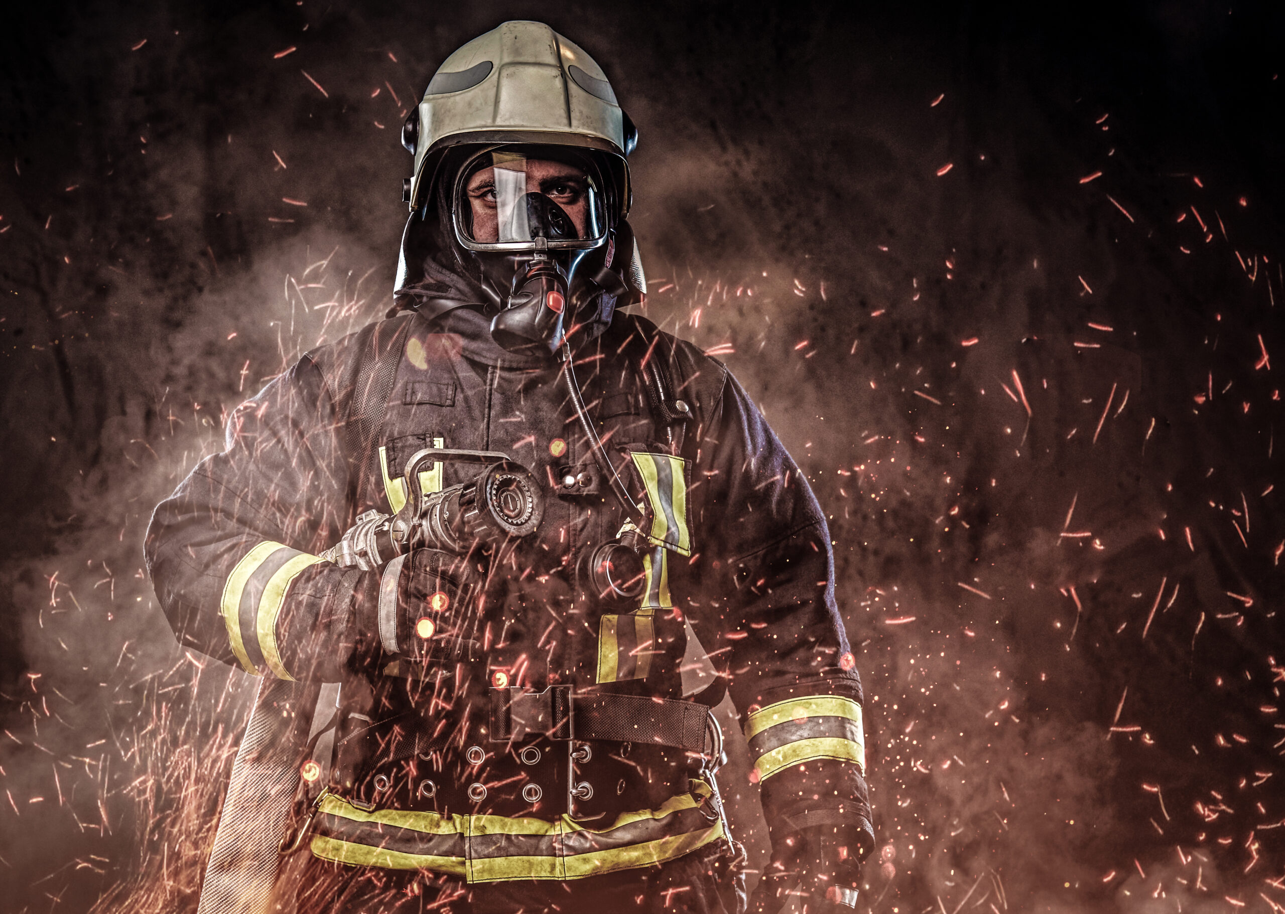a firefighter dressed in a uniform in a studio.